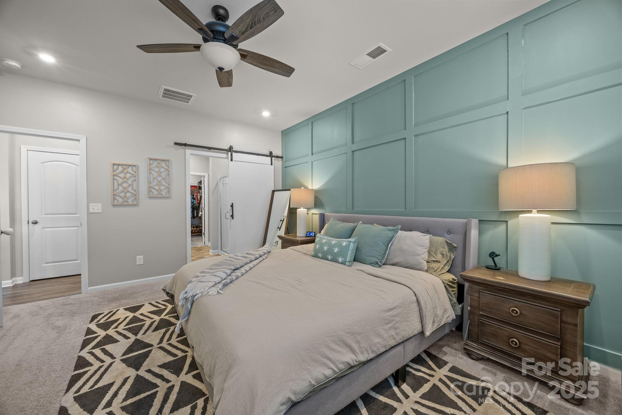 567 Sitka Drive York, SC 29745 - Photo 18 of 40 a bedroom with a bed and a chandelier