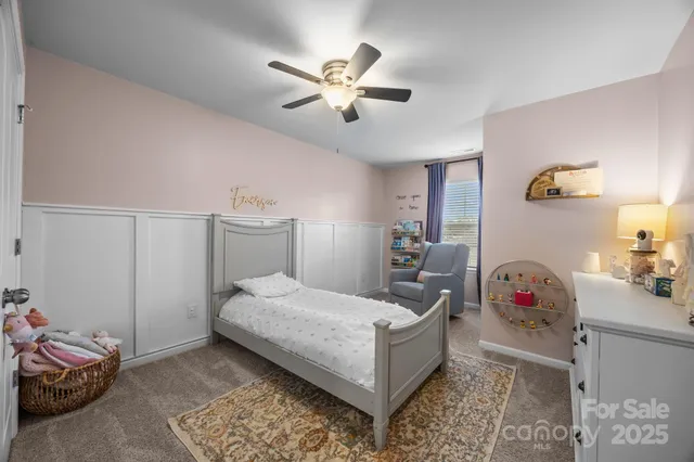 a spacious bedroom with a bed and a chandelier