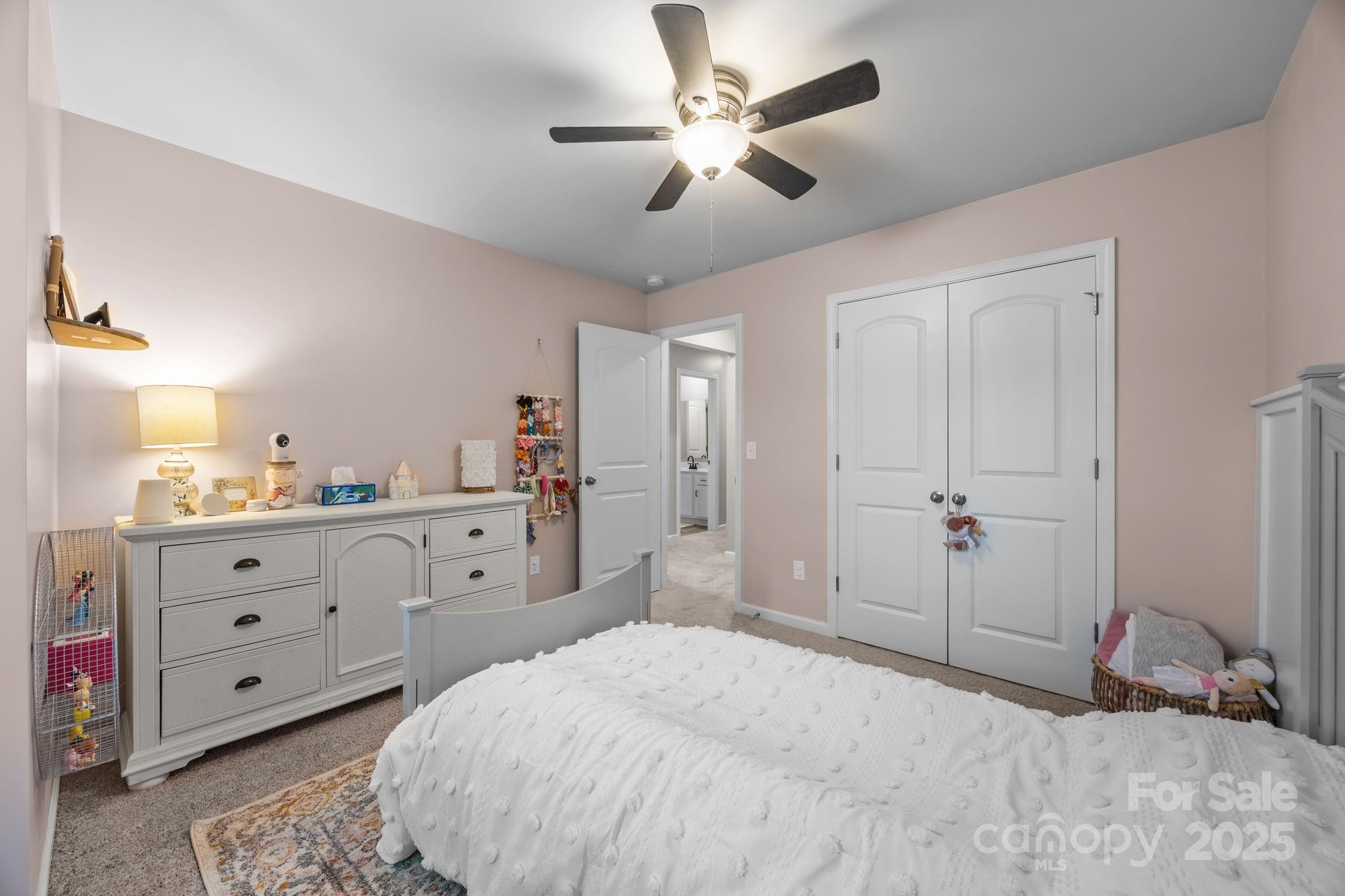 567 Sitka Drive York, SC 29745 - Photo 27 of 40 a spacious bedroom with a bed and a chandelier