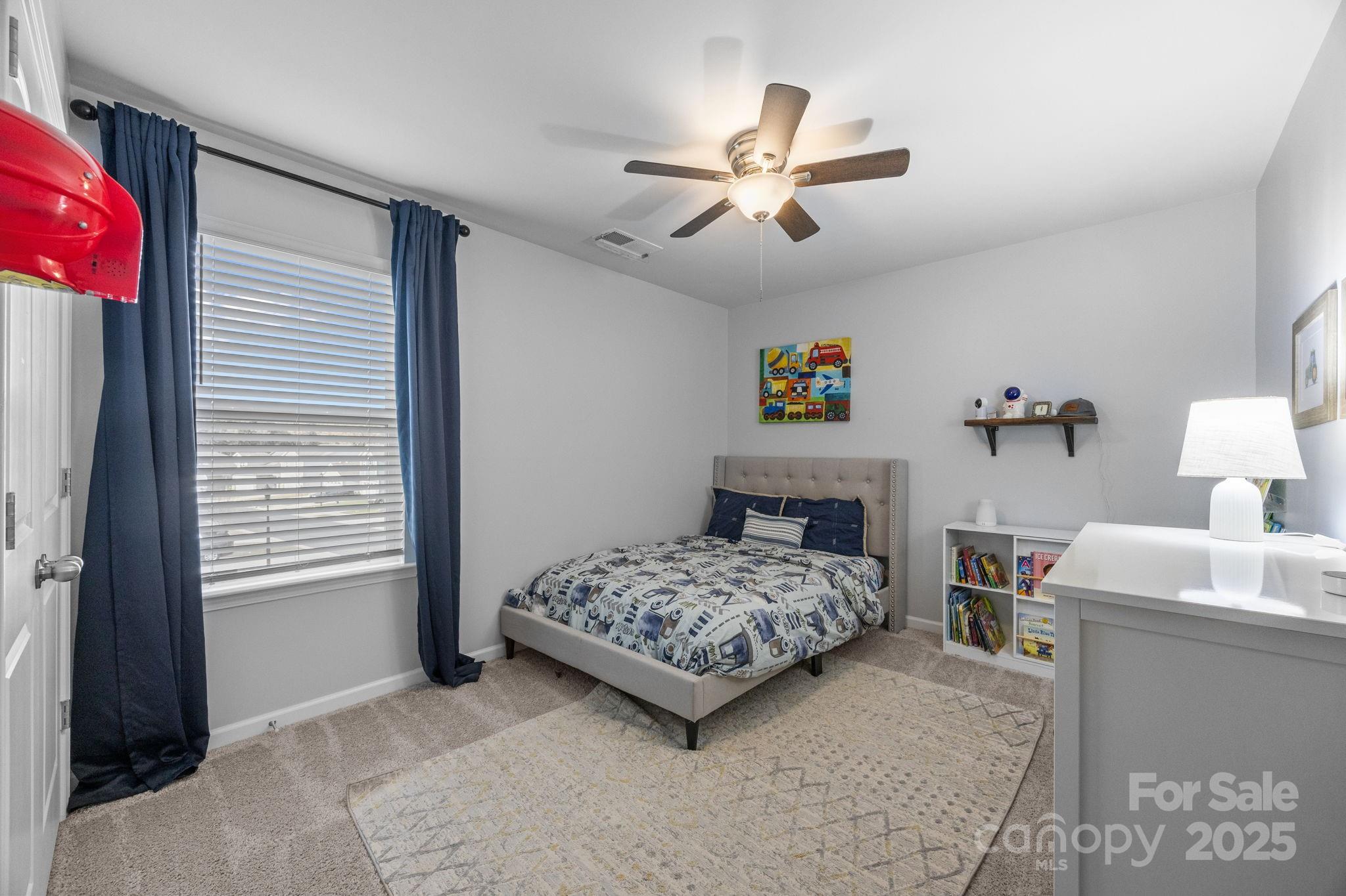 567 Sitka Drive York, SC 29745 - Photo 31 of 40 a bedroom with a bed and a chandelier