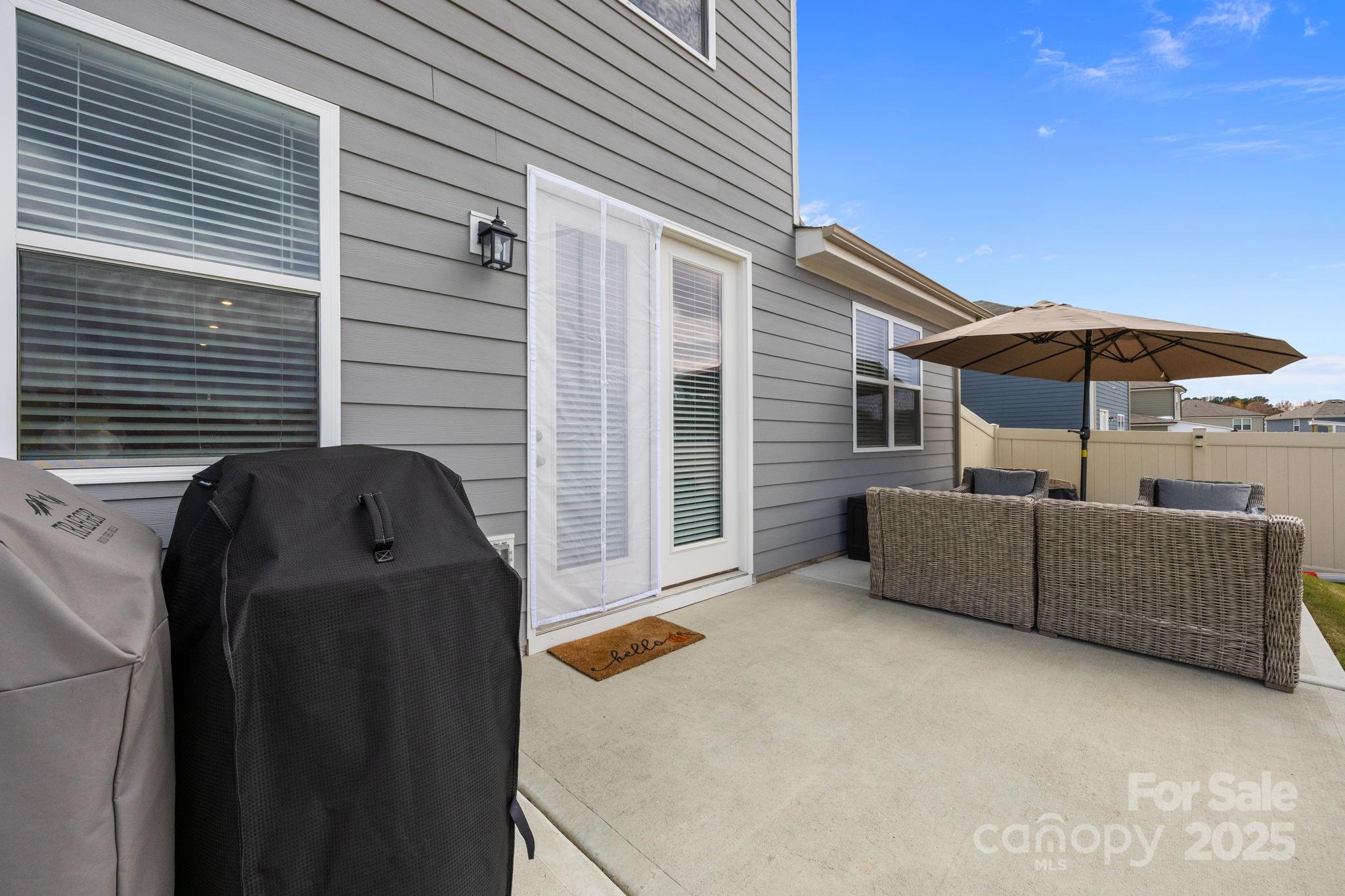 567 Sitka Drive York, SC 29745 - Photo 34 of 40 a view of backyard with furniture and umbrella