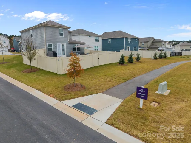 a kitchen with a dining table chairs wooden floor stainless steel appliances and cabinets