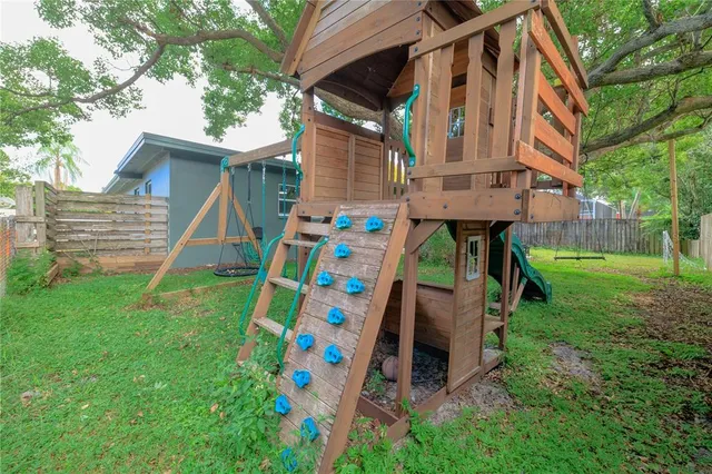 a view of an house with backyard space and porch