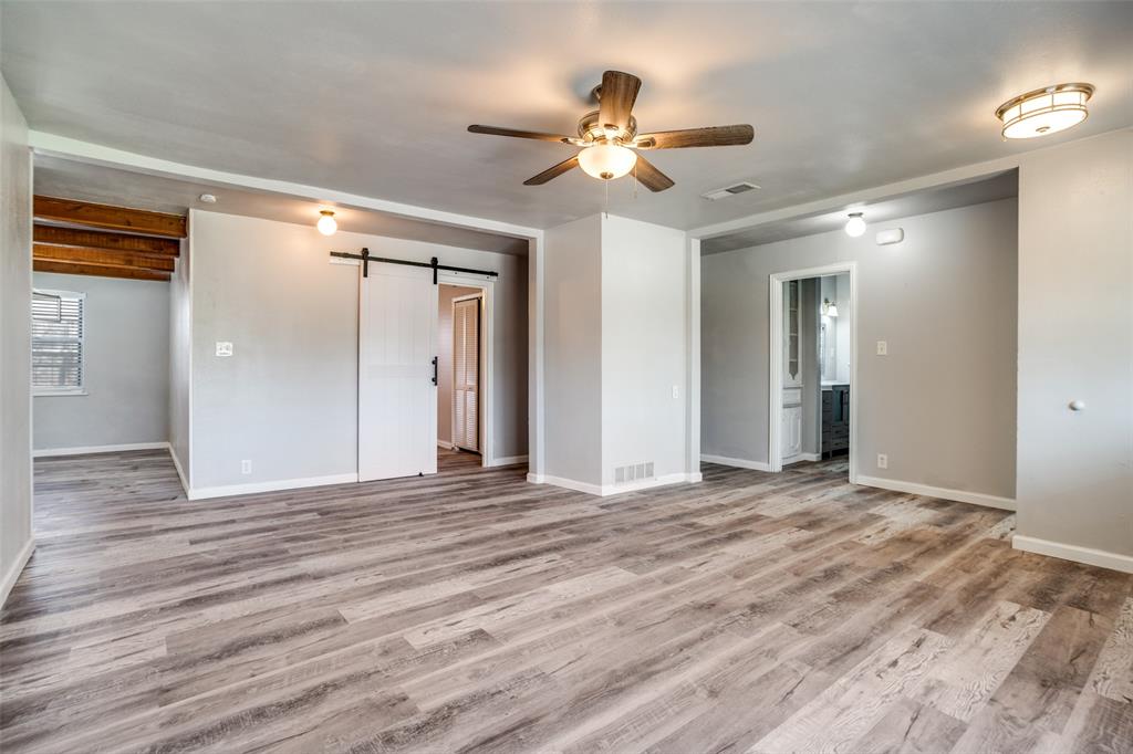266 West Fulton Street Van Alstyne, TX 75495 - Photo 2 of 13 a view of an empty room with wooden floor
