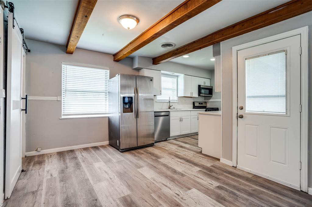 266 West Fulton Street Van Alstyne, TX 75495 - Photo 4 of 13 a kitchen with a refrigerator a sink and cabinets