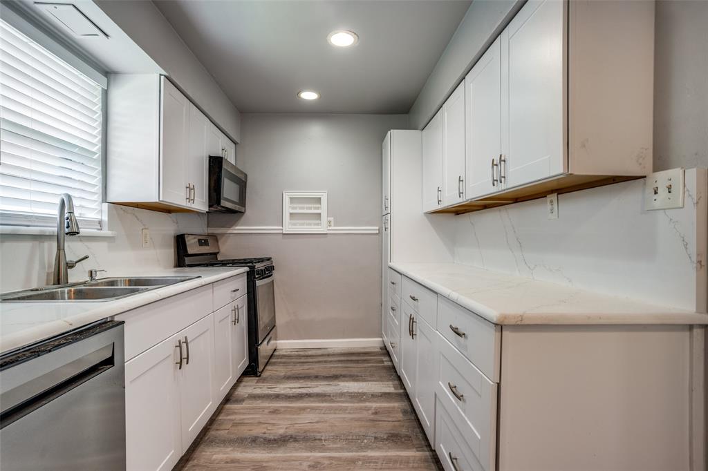 266 West Fulton Street Van Alstyne, TX 75495 - Photo 6 of 13 a kitchen with granite countertop white cabinets and white appliances