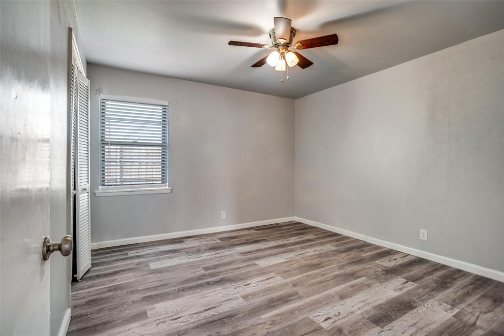 266 West Fulton Street Van Alstyne, TX 75495 - Photo 8 of 13 wooden floor in an empty room with a window