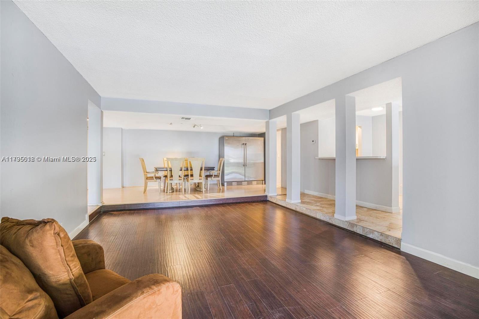 3650 Inverrary Drive, Unit 3P Lauderhill, FL 33319 - Photo 11 of 40 a living room with furniture and a wooden floor
