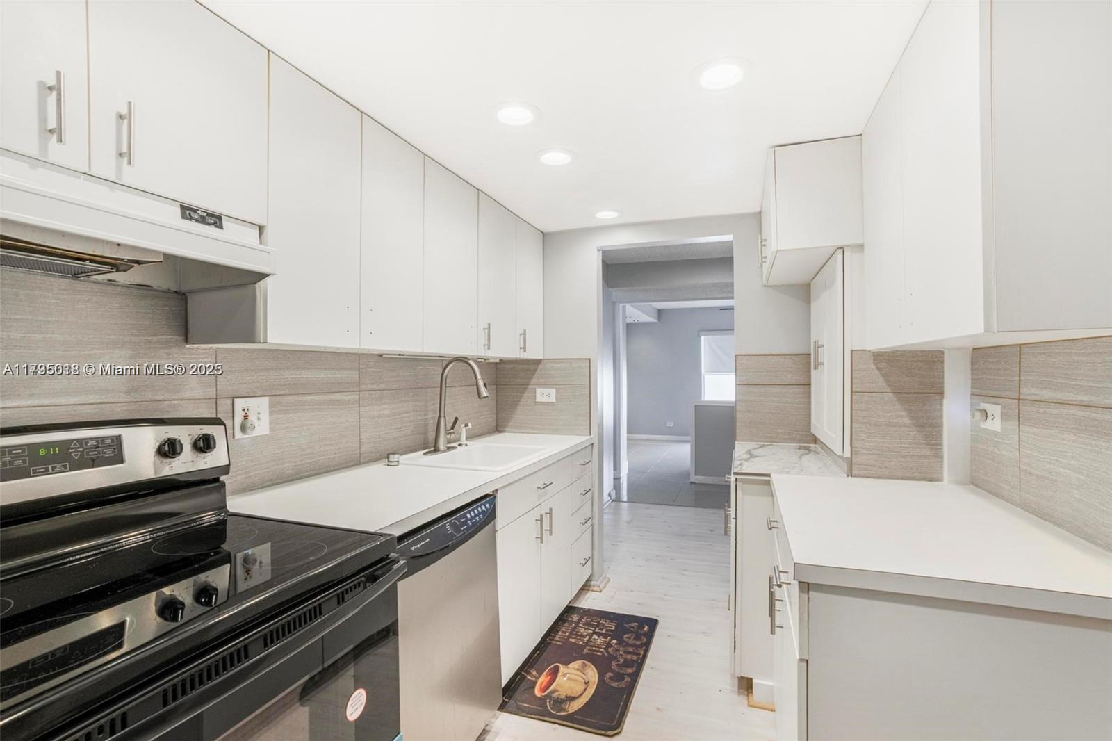 3650 Inverrary Drive, Unit 3P Lauderhill, FL 33319 - Photo 15 of 40 a kitchen with a sink appliances and cabinets