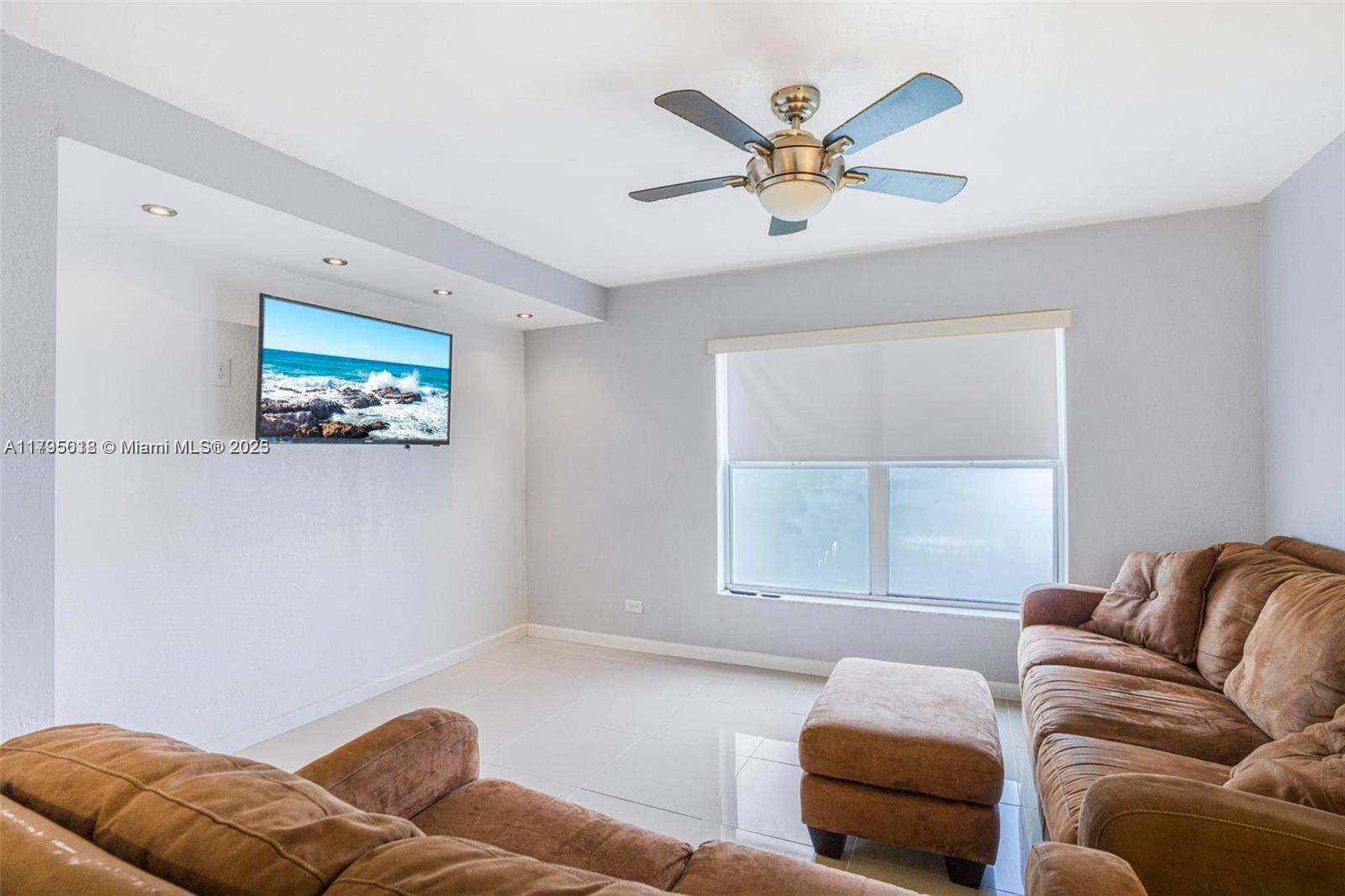 3650 Inverrary Drive, Unit 3P Lauderhill, FL 33319 - Photo 17 of 40 a living room with furniture and a large window