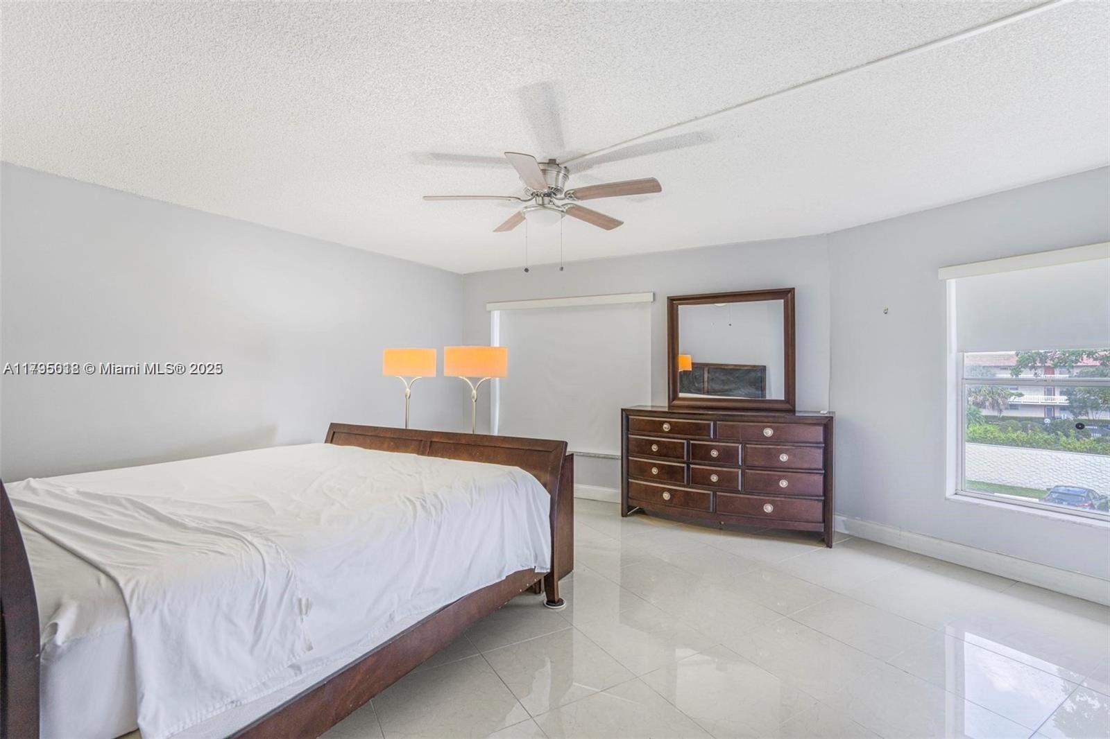 3650 Inverrary Drive, Unit 3P Lauderhill, FL 33319 - Photo 18 of 40 a bedroom with a bed and a dresser