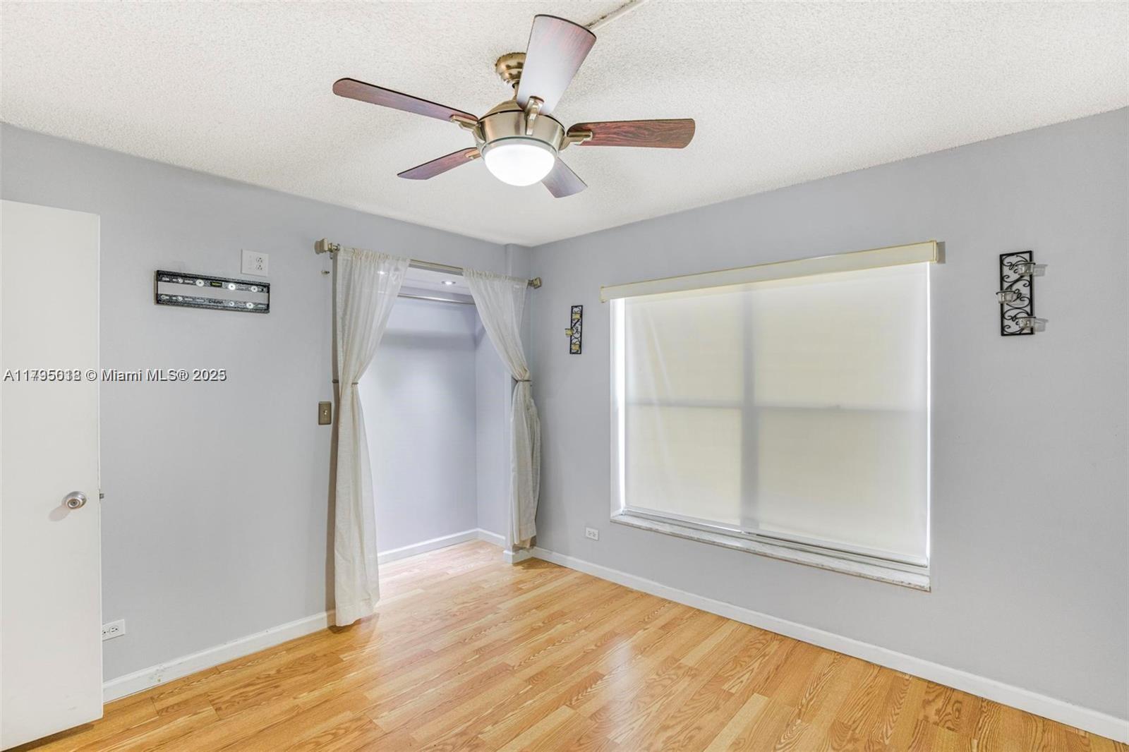3650 Inverrary Drive, Unit 3P Lauderhill, FL 33319 - Photo 20 of 40 a view of an empty room with wooden floor and a window