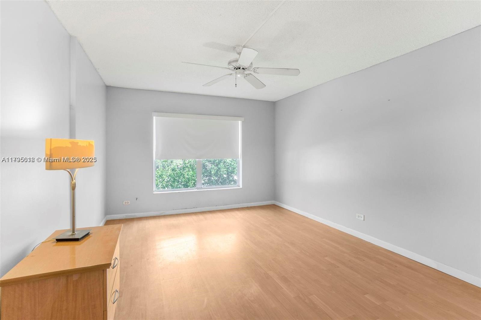 3650 Inverrary Drive, Unit 3P Lauderhill, FL 33319 - Photo 22 of 40 wooden floor in an empty room with a window