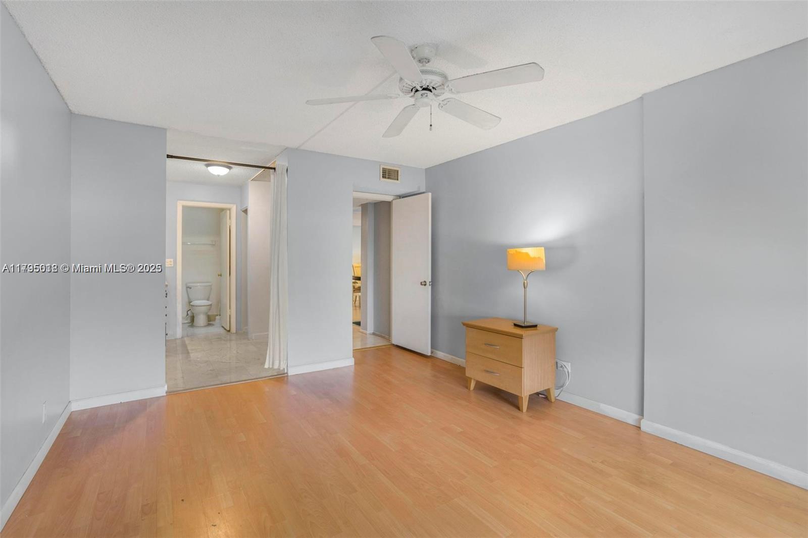 3650 Inverrary Drive, Unit 3P Lauderhill, FL 33319 - Photo 23 of 40 a bedroom with a bed and a chandelier