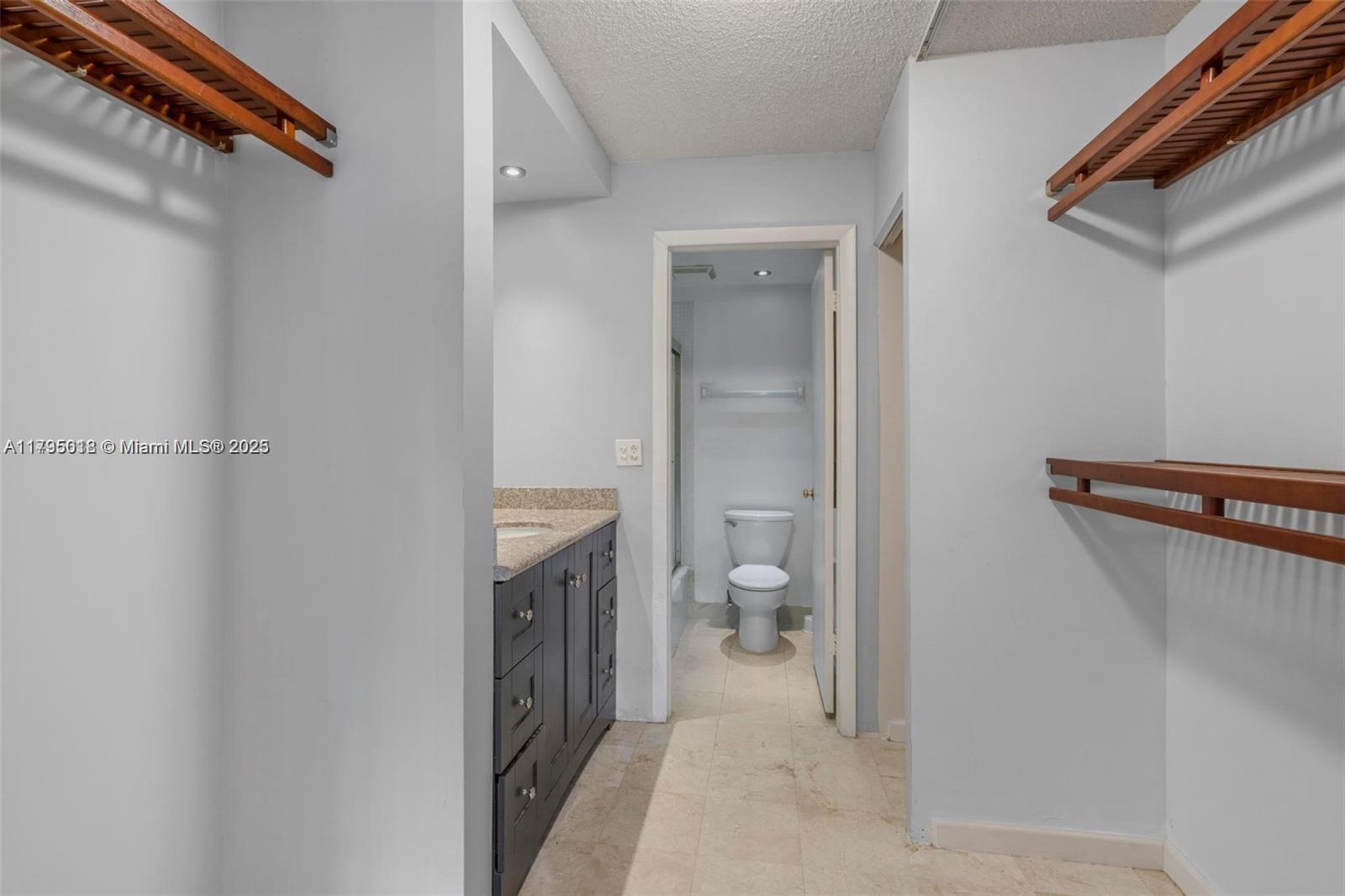 3650 Inverrary Drive, Unit 3P Lauderhill, FL 33319 - Photo 24 of 40 a bathroom with a toilet sink and vanity