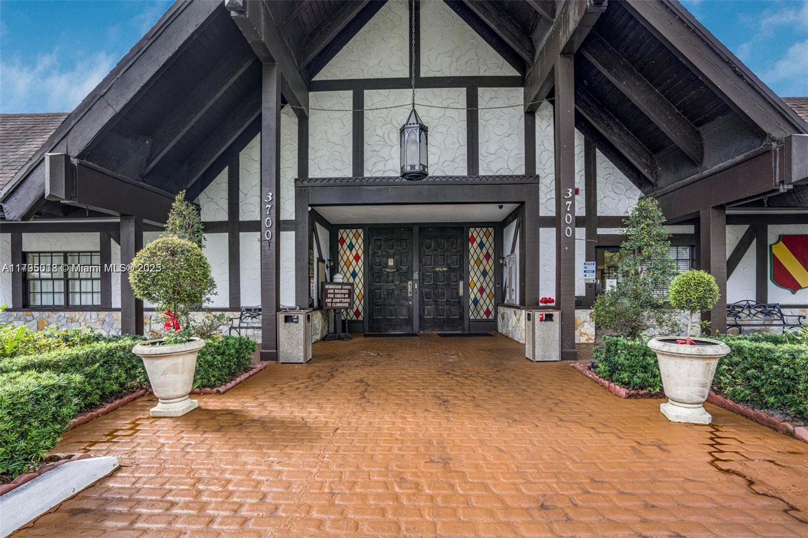 3650 Inverrary Drive, Unit 3P Lauderhill, FL 33319 - Photo 28 of 40 a view of a house with potted plants and a table and chairs