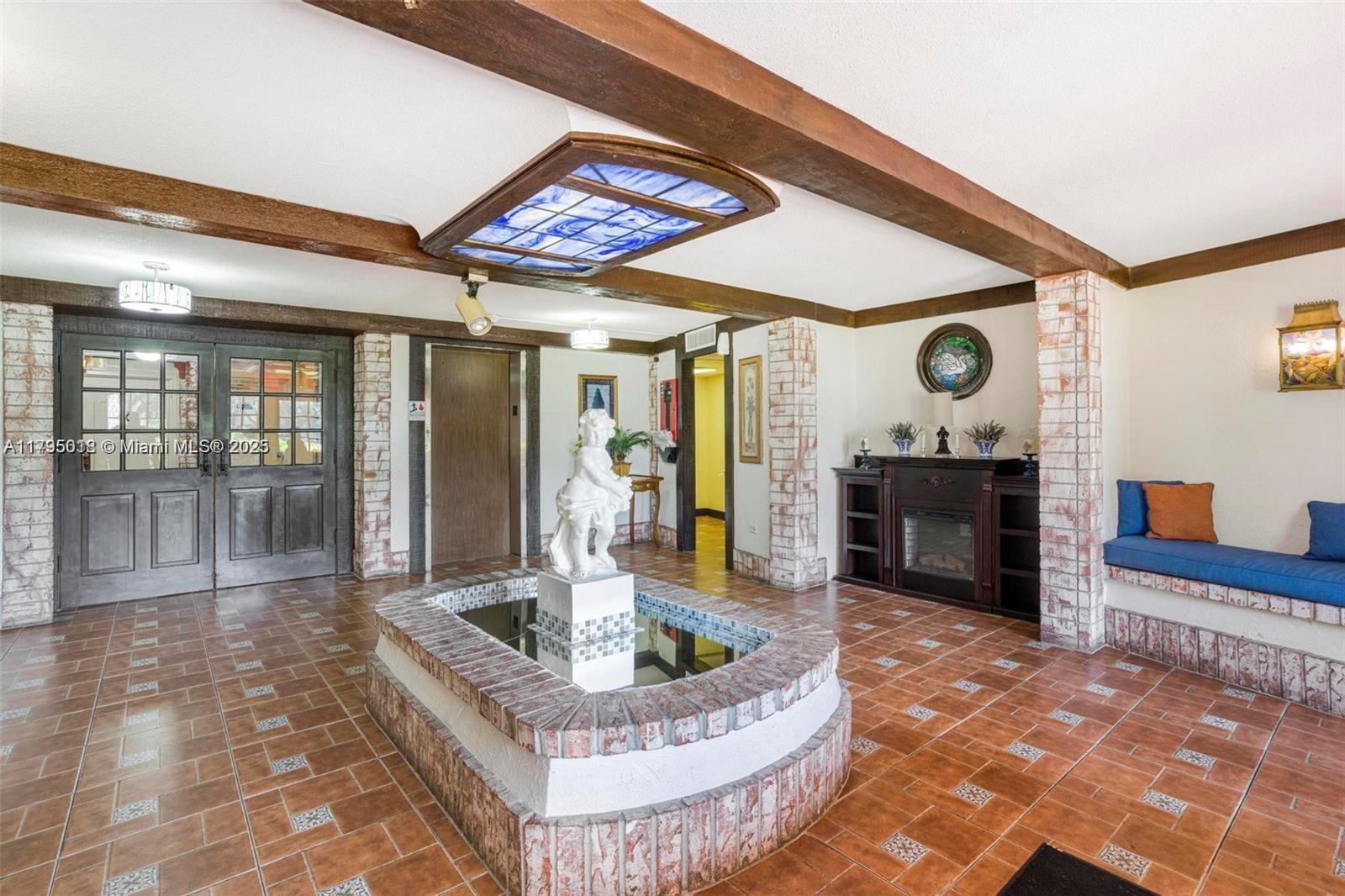 3650 Inverrary Drive, Unit 3P Lauderhill, FL 33319 - Photo 5 of 40 a living room with fireplace furniture and a large window