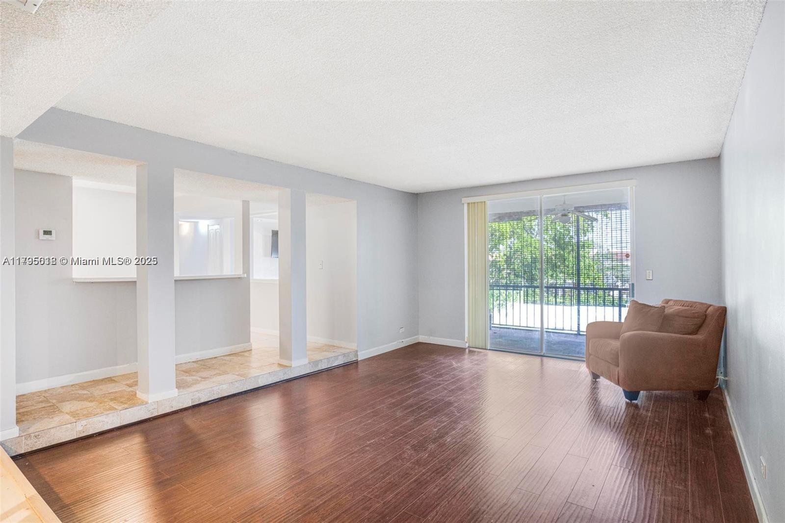 3650 Inverrary Drive, Unit 3P Lauderhill, FL 33319 - Photo 9 of 40 a furnished livingroom with windows and wooden floor
