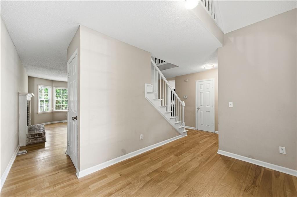 5017 Sandyhook Court Northwest Acworth, GA 30102 - Photo 11 of 43 a view of a hallway view with wooden floor and staircase