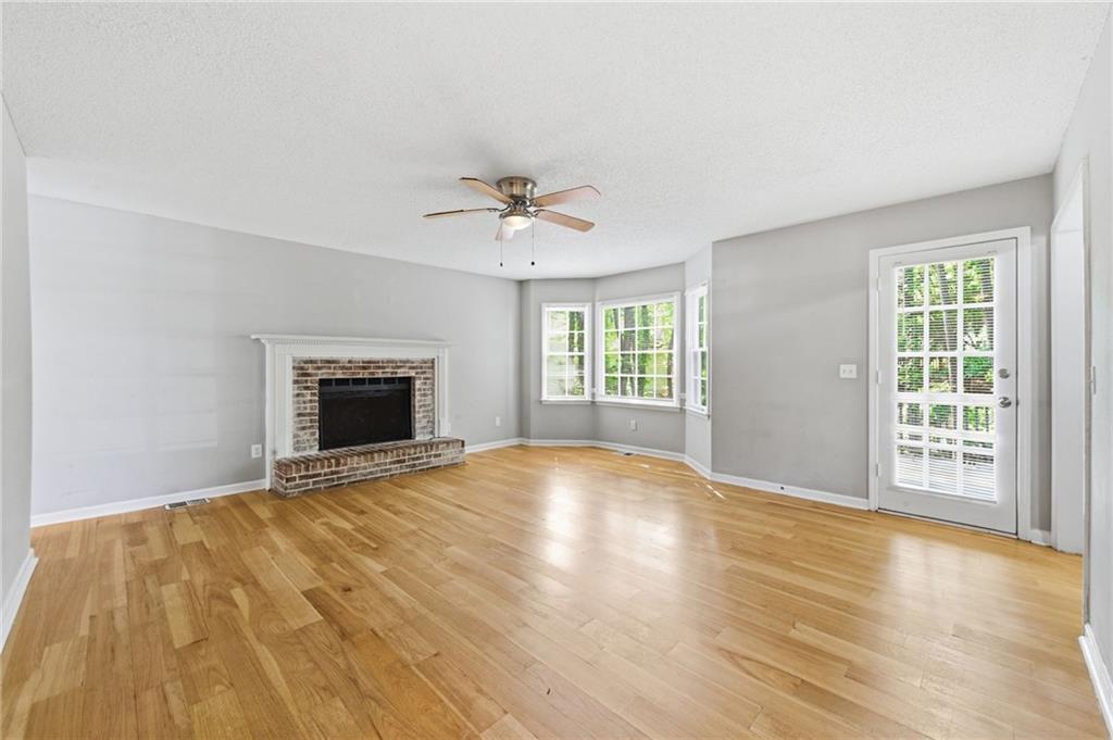 5017 Sandyhook Court Northwest Acworth, GA 30102 - Photo 14 of 43 an empty room with windows fireplace and a sink