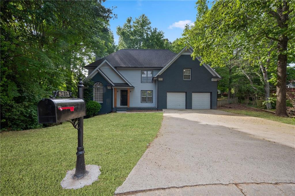 5017 Sandyhook Court Northwest Acworth, GA 30102 - Photo 2 of 43 a front view of a house with a yard and trees