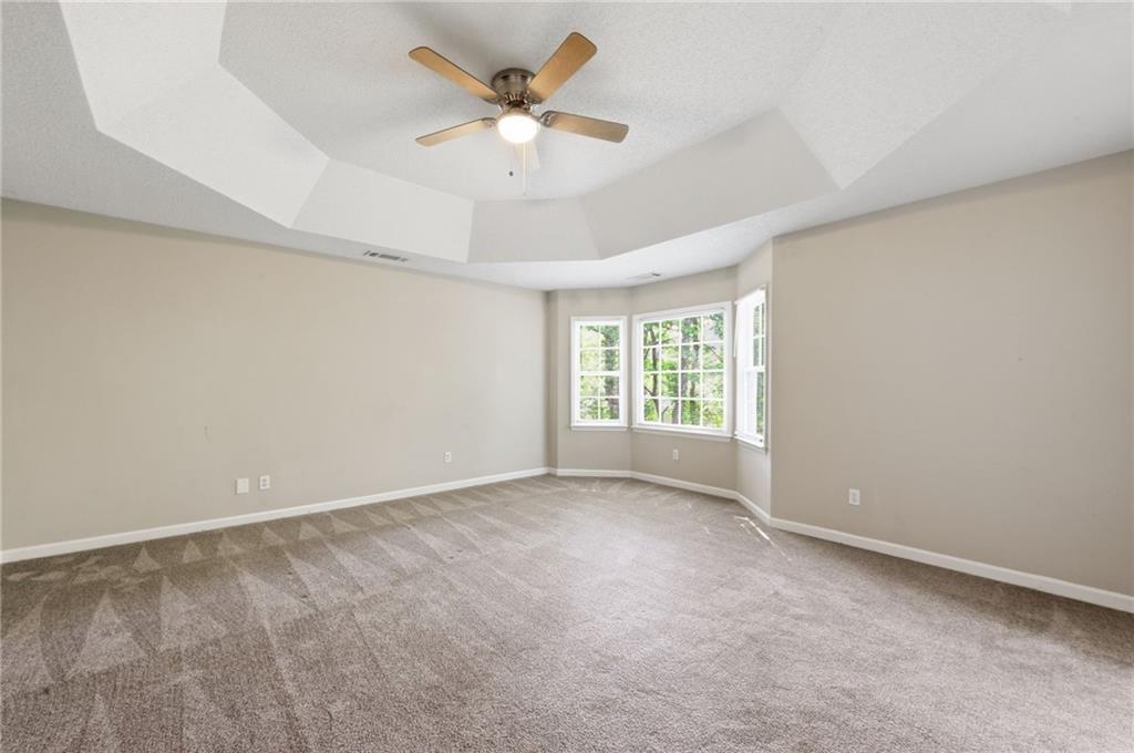 5017 Sandyhook Court Northwest Acworth, GA 30102 - Photo 29 of 43 an empty room with a empty space and a ceiling fan