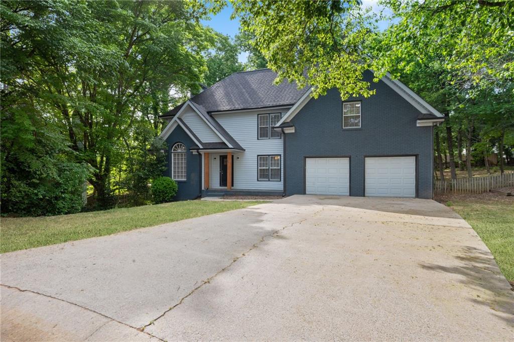 5017 Sandyhook Court Northwest Acworth, GA 30102 - Photo 3 of 43 a house with a yard plants and large tree