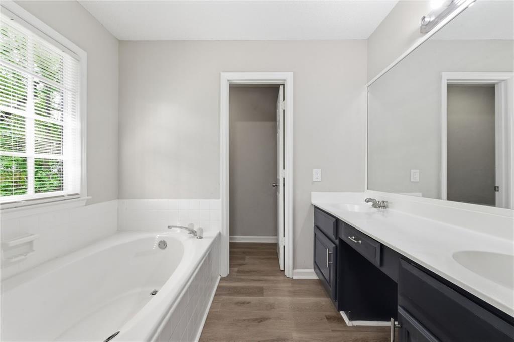 5017 Sandyhook Court Northwest Acworth, GA 30102 - Photo 32 of 43 a bathroom with a tub sink and mirror