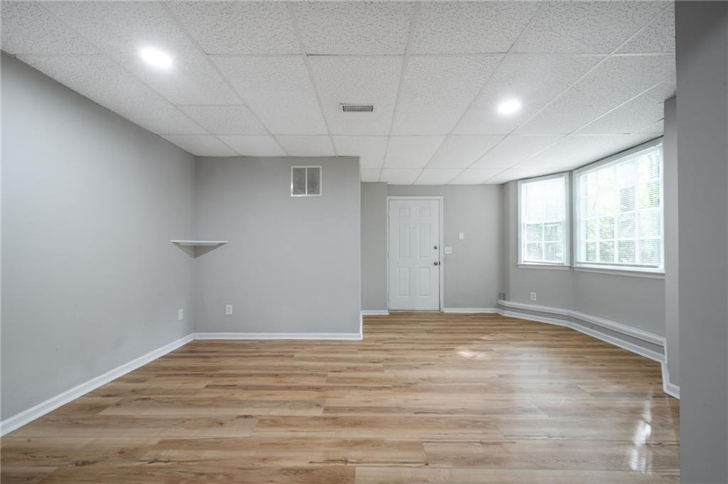 5017 Sandyhook Court Northwest Acworth, GA 30102 - Photo 42 of 43 a view of an empty room with wooden floor and a window