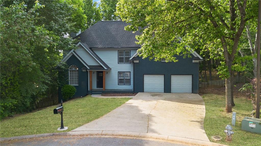 5017 Sandyhook Court Northwest Acworth, GA 30102 - Photo 5 of 43 a front view of a house with a garden and trees