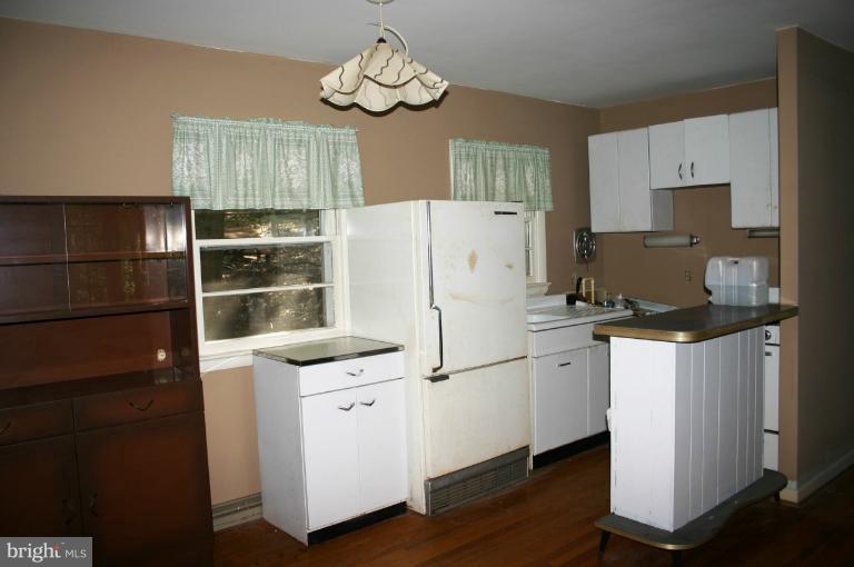 98 Highview Road Harpers Ferry, WV 25425 - Photo 1 of 11 a kitchen with a refrigerator a stove cabinets and wooden floor
