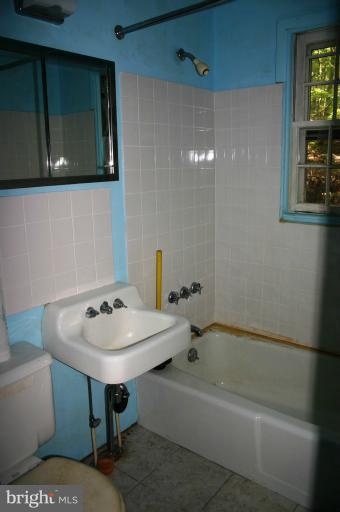 98 Highview Road Harpers Ferry, WV 25425 - Photo 4 of 11 a bathroom with a sink a toilet and bathtub