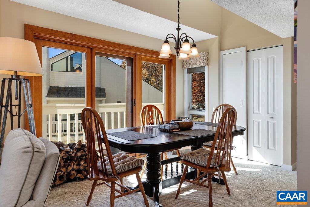 1469 The Ledges Roseland, VA 22967 - Photo 7 of 35 a dining room with furniture a chandelier and wooden floor