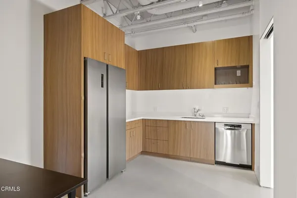 a kitchen with stainless steel appliances granite countertop a refrigerator and a sink