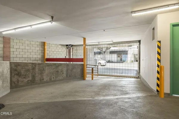a view of parking garage with cars