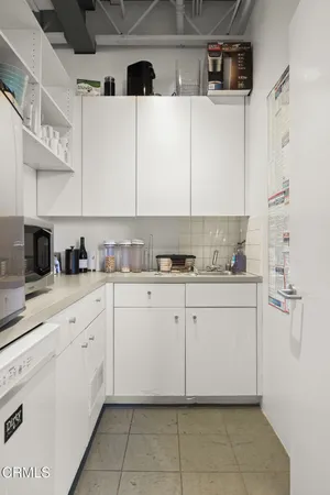 a kitchen with a white cabinets and white appliances