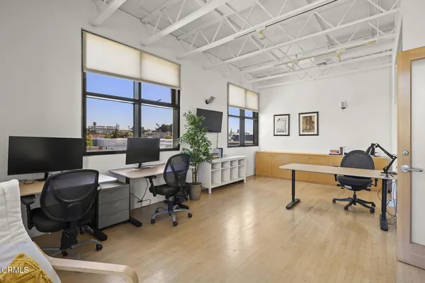 a view of a livingroom with workspace and a window