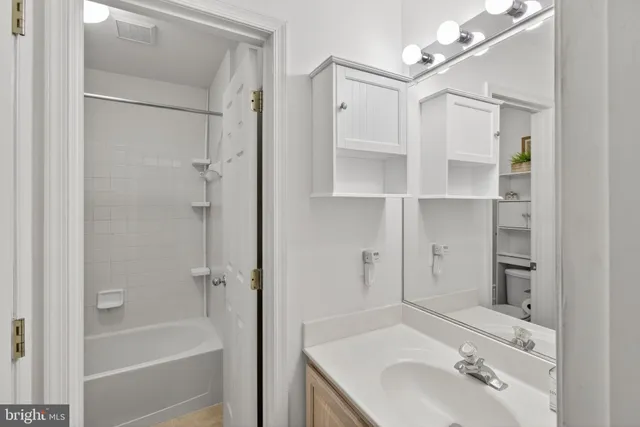 a bathroom with a sink toilet tub and shower