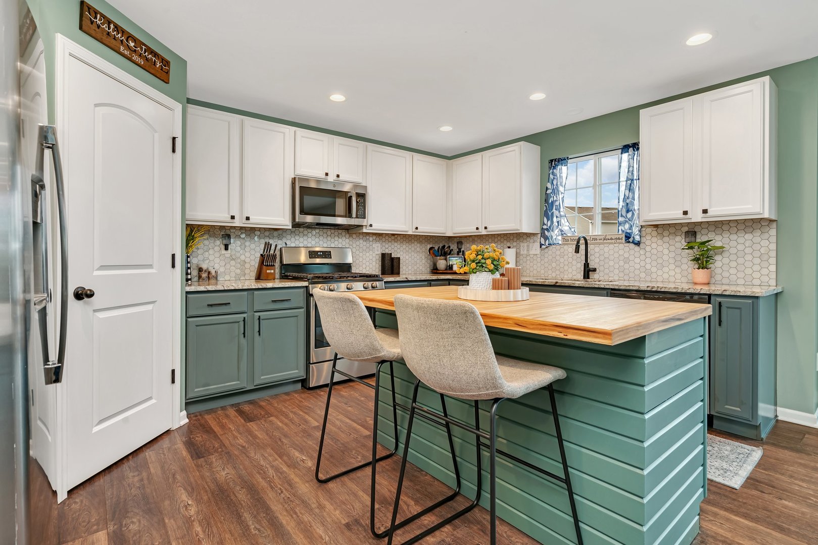 1901 Locust Road Morris, IL 60450 - Photo 9 of 30 a kitchen with stainless steel appliances granite countertop a sink a stove a refrigerator cabinets and a dining table with wooden floor