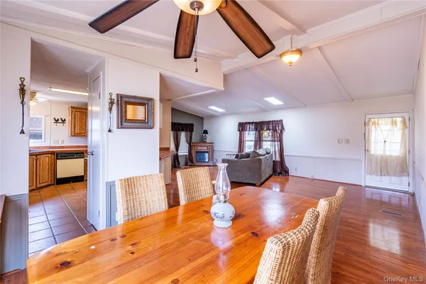 a living room with furniture and kitchen view