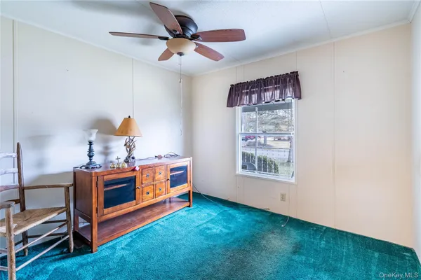 a view of room with window and a ceiling fan