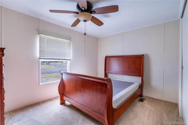a view of a bedroom with closet and windows