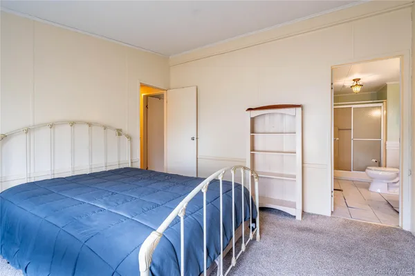 a bathroom with a granite countertop sink toilet a mirror and shower