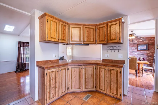 a kitchen with stainless steel appliances granite countertop a refrigerator a sink dishwasher and cabinets with wooden floor