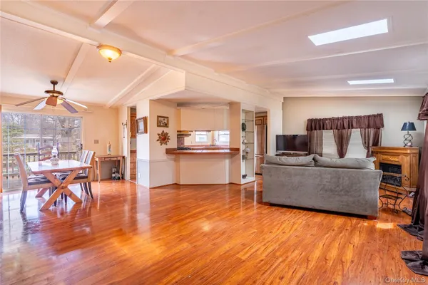a living room with furniture and kitchen view