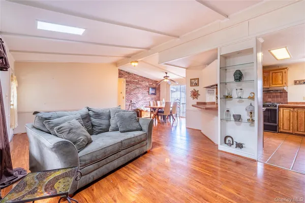 a living room with furniture and view of kitchen