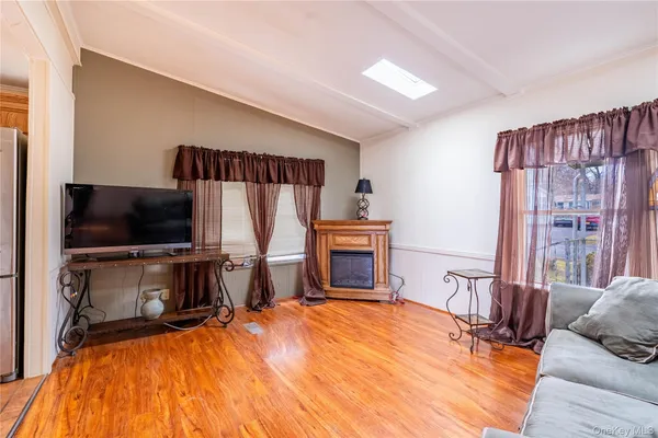 a bed room with a bed a television and a window