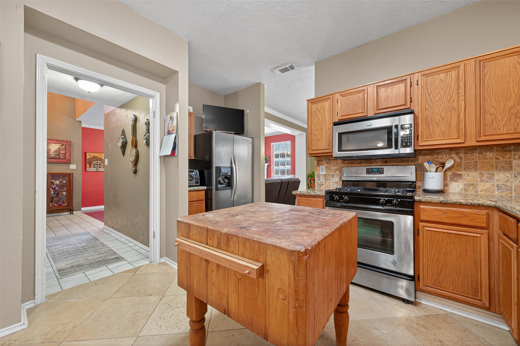 17215 Chaseloch Street Spring, TX 77379 - Photo 17 of 32 a kitchen with stainless steel appliances granite countertop a stove refrigerator and microwave