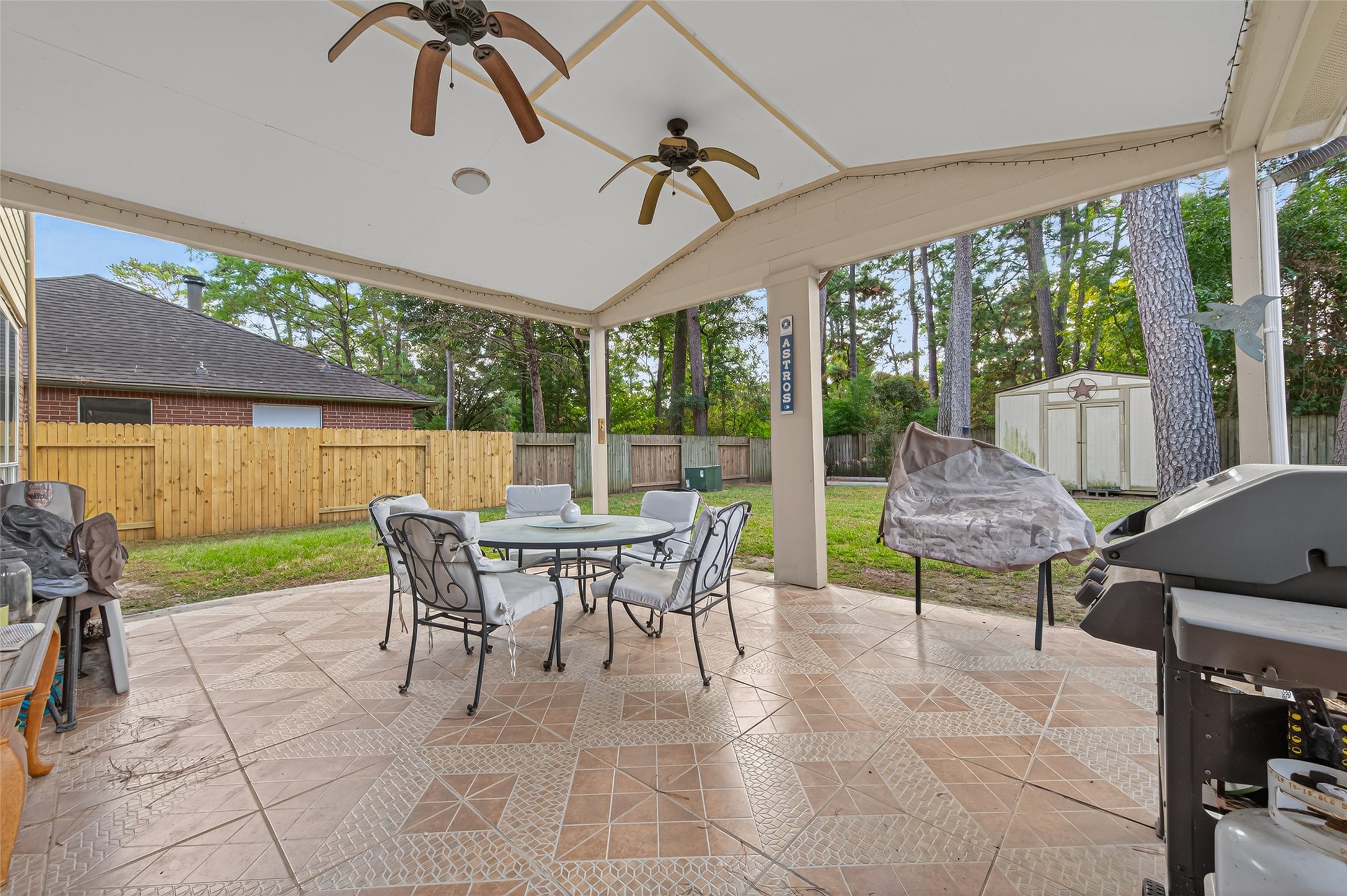 17215 Chaseloch Street Spring, TX 77379 - Photo 30 of 32 a view of a patio with a table chairs and a backyard
