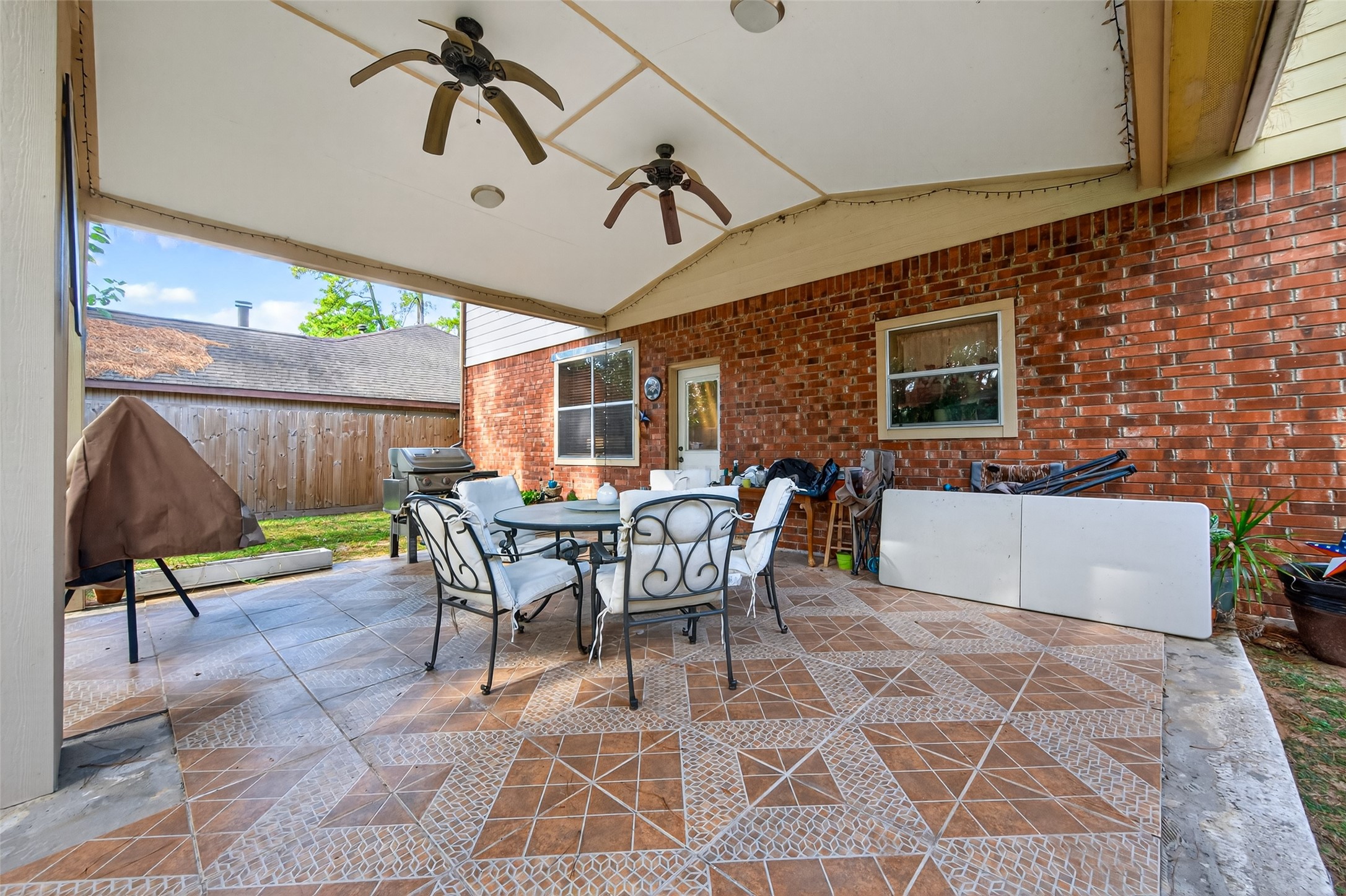 17215 Chaseloch Street Spring, TX 77379 - Photo 31 of 32 a view of a patio with table and chairs with wooden floor and fence